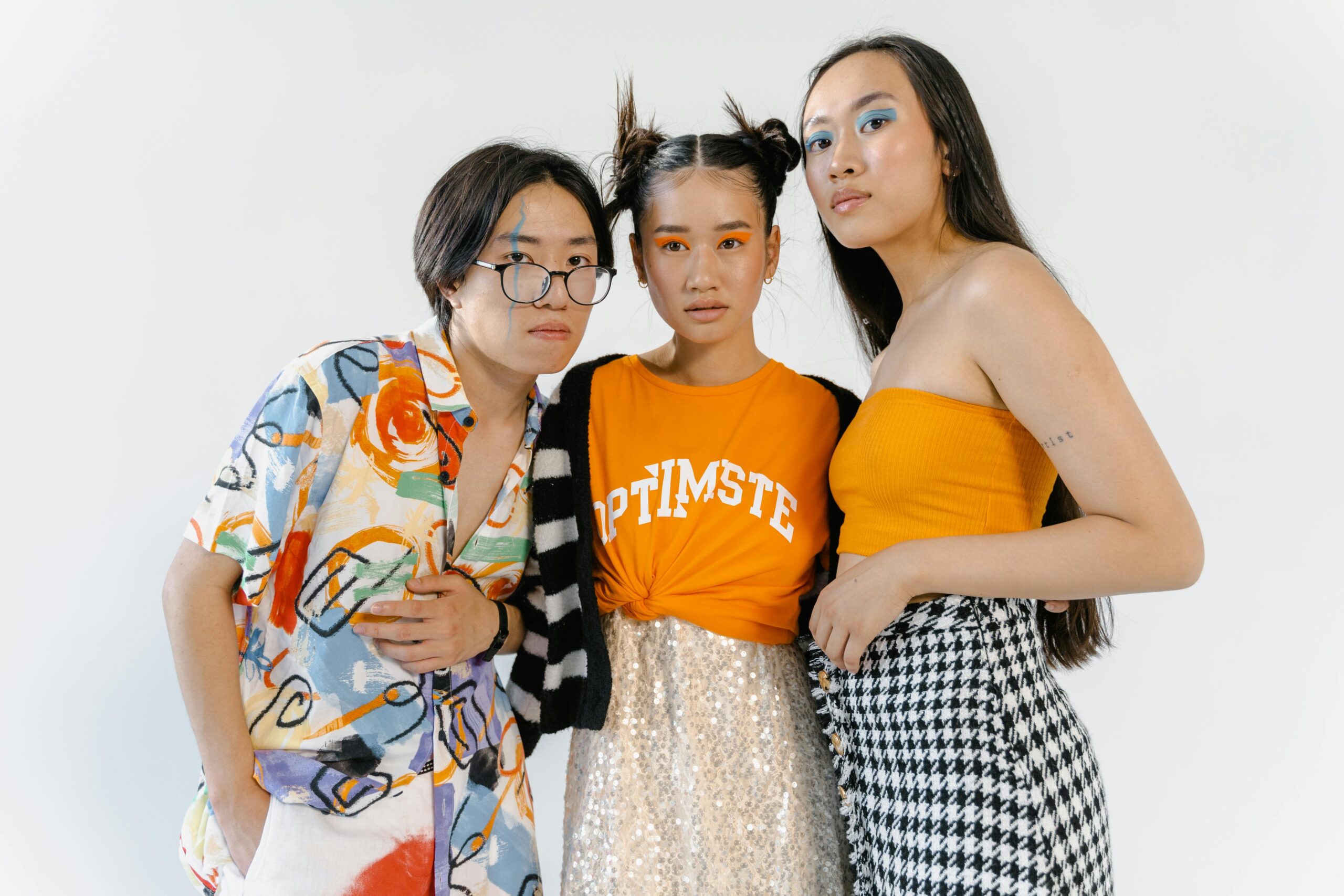 Trendy group studio shoot showcasing vibrant fashion and makeup.